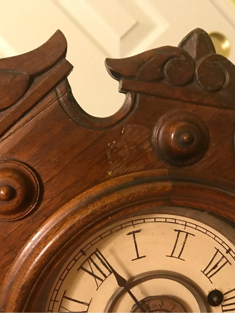 Ornate Brown Wooden Wall Clock with Roman Dial
